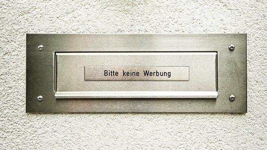 Briefkasten auf verputztem Hintergrund mit der Aufschrift "Bitte keine Werbung"